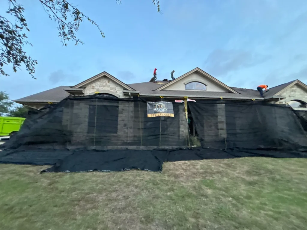 Catch-All debris netting hung from the gutters to the lawn during a roof replacement in Liberty Hill, TX
