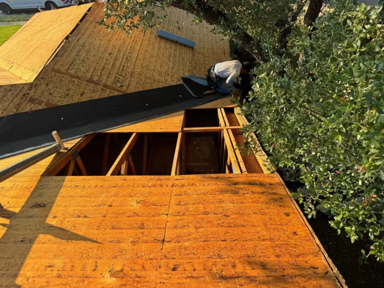 Damaged roof decking removed down to the rafters with new leak barrier going down on a Cedar Park, TX roof