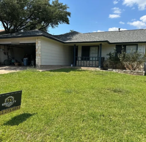 Completed roof replacement on a Cedar Park, TX 78613 home with a TX Specialty Roofing yard sign
