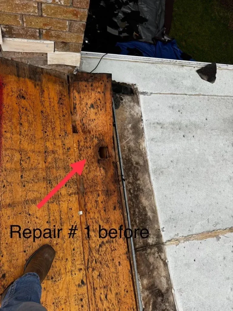 Rotted roof decking with a hole near the chimney uncovered during tear-off in Georgetown, TX
