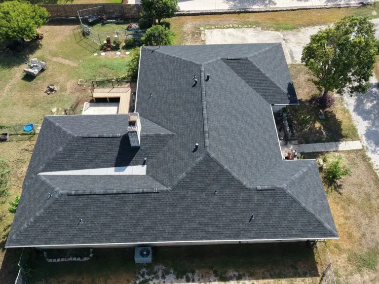 Overhead drone view of the rear hip roof and chimney after a full tear-off in Helotes, TX