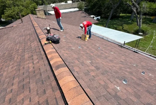 Solar crew installing flashed solar panel mounts on a new shingle roof in Helotes, TX