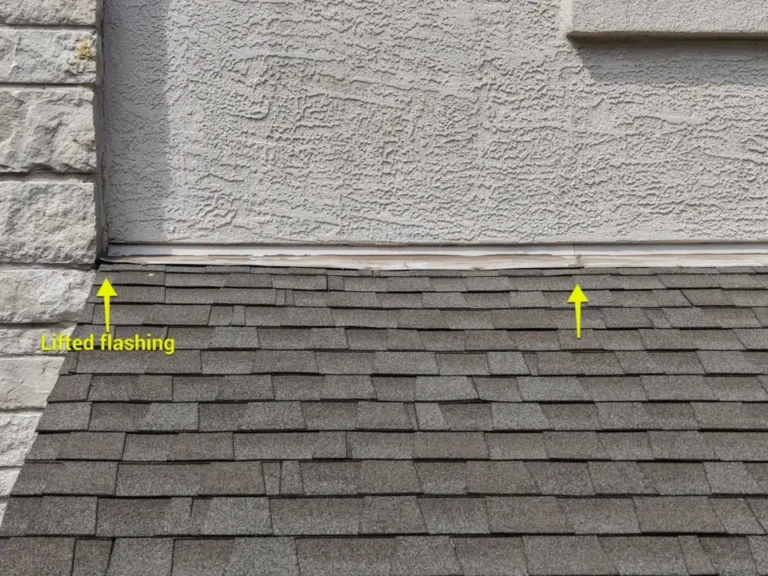 Lifted flashing where a stucco wall meets a shingle roof, marked with arrows during an inspection
