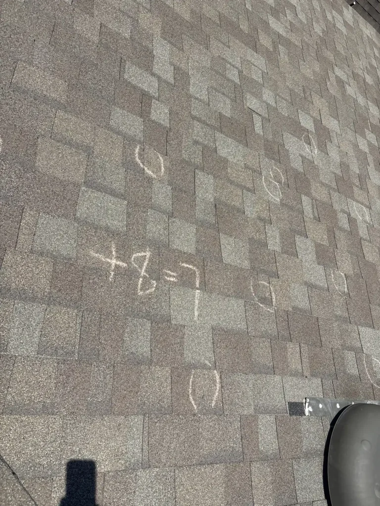 Left roof slope marked L=8+ with chalk-circled hail hits near a roof vent on a Uhland, TX home