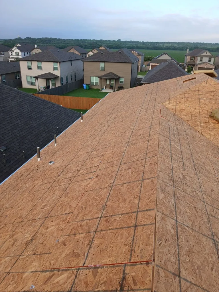 Bare OSB roof decking after the old shingles were torn off a home in Uhland, TX